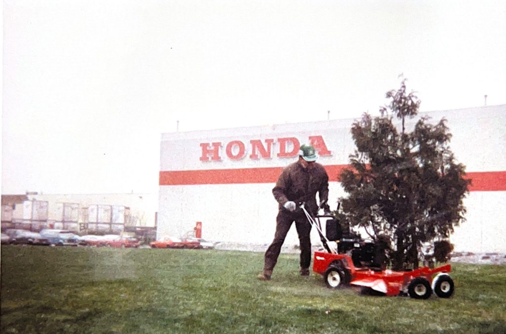 Premier Landscaping founder at the Honda Canada site, showcasing large-scale commercial lawn services.